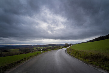 Stormy clouds over the road on the hill