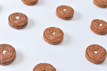 Cookies laid out in rows on white background. Illustrating and visualization of collecting cookie web data on the user's computer.