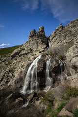 Long exposure of a high waterfall in the middle of the mountain from a spring in Madrid, Spain. Cascade of the litueros.