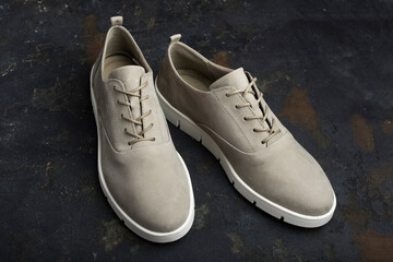 Stylish female shoes gray on black background. Comfortable shoes for women, close-up. Beauty and Fashion Concept