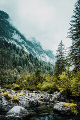 Moody mountain scene on a dark rainy weather spring day with low hanging clouds. Alps mountains, Austria