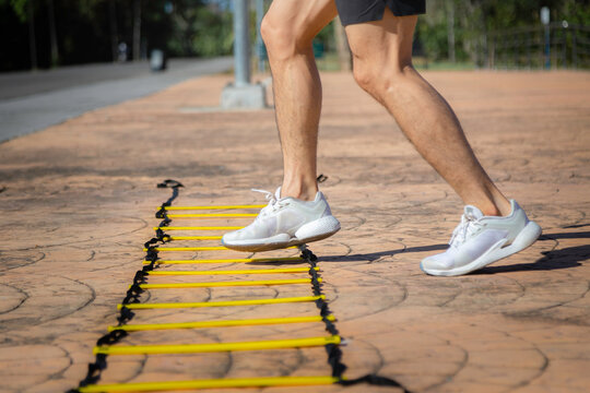 Young Asian Man Is Training His Movement Skill On An Agility  Ladder.