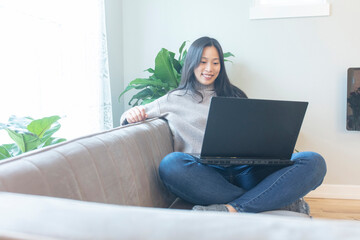 Asian female office worker doing household remote working at home