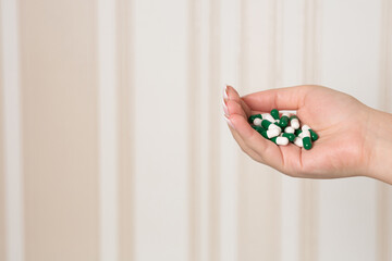 Woman holding many pills in her hand