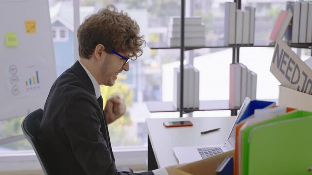Office workers are stressed and exhausted from their hard work, he smashes the table with his hand in anger
