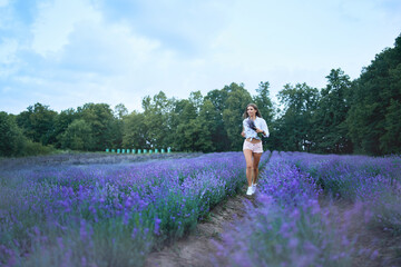 Charming woman running in lavender field.