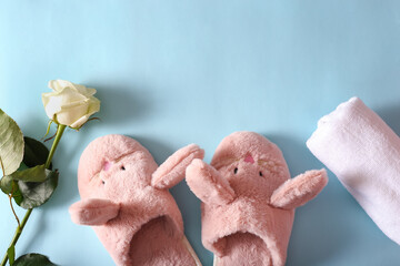women's slippers and towels on a blue background