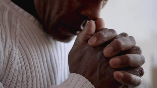 man praying to god with hands together Caribbean man praying with white background stock videos