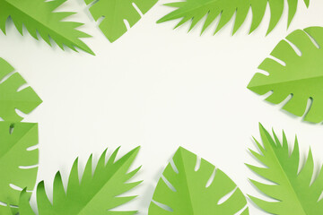 Tropical decor top view. Paper palm, monstera leaves frame. Jungle Banner with Copy Space. Summer travel concept