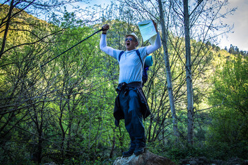 exultant mountaineer crowning the mountain peak