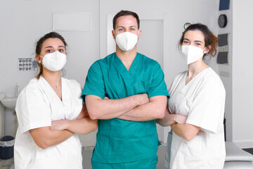 Diverse team of healthcare professionals wearing protective face mask, working at a physical rehabilitation clinic during coronavirus pandemic. High quality photo