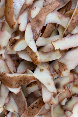 Fresh potato peelings on the table. Made in natural light, soft shadows.