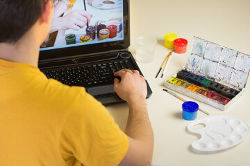 Online art course. Distance education. Artist equipment paintbrush, paint, colored pencils and...