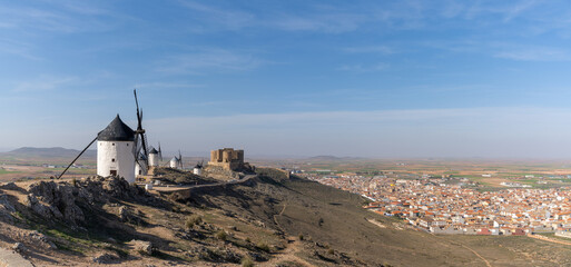 view of the windmills and castle of Consuegra in La Mancha in central Spain