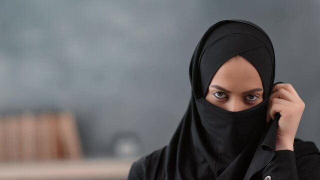 Portrait of pretty Muslim woman covering niqab face apart from eyes. Shot with RED camera in 4K