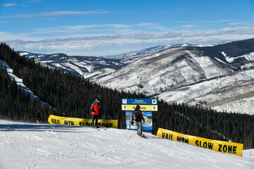 Vail ski resort mounrtain view with slow zone yellow sign