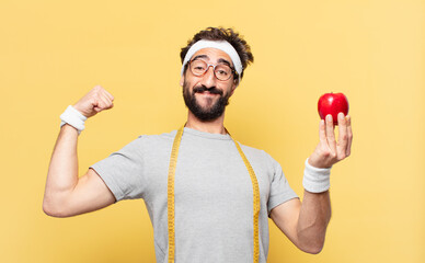 young crazy bearded athlete happy expression and holding an apple and holding an apple