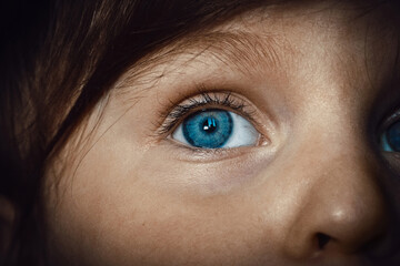 Blue eye of a three-year-old Caucasian girl. Close-up
