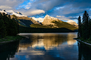 Sunset across Maligne Lake as the surrounding peaks reflect in the water