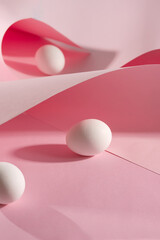 Pink pastel easter eggs with wave paper pink background