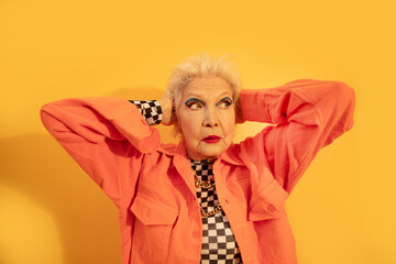 Shocked woman looking away with puzzled emotions while posing at the studio