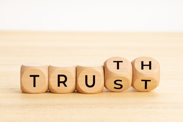 Truth or trust concept. Text on wooden blocks. White background. Copy space