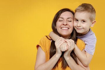 Happy young woman have fun with cute child baby boy 5-6-7 years old in violet t-shirt. Mommy little...