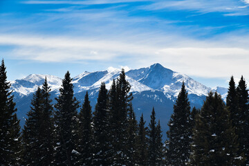Vail ski resort in winter time with snow in the Colorado Rocky Mountains - White clouds over the...