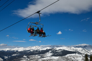 Fototapeta na wymiar Ski chair lift with skiers. Ski resort in Vail, Colorado, USA