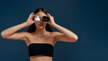 Young girl with creams near the face