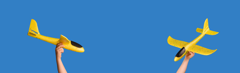 Yellow toy plane on a blue background. Traveling concept.