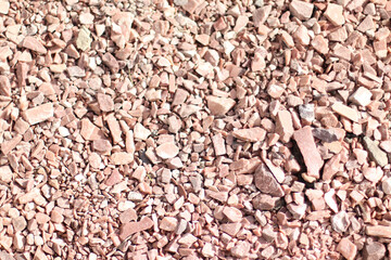 Small brown pebbles stone wall texture background