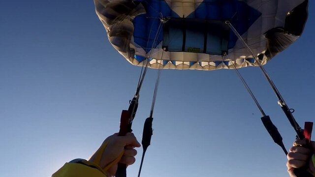 Skydiver open his parachute, point of view.