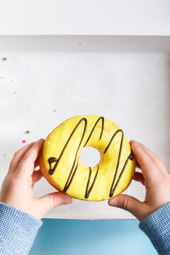 Child's Hand Reaching To Grab Doughnut