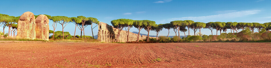 Fototapeta na wymiar Ruins of the ancient aqueduct on Appia Way near Villa Quintili i