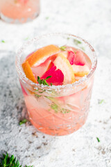 Grapefruit drinks with ice cubes and thyme