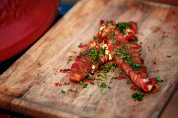 Sweet red pepper stuffed with cream cheese, wrapped in bacon and grilled