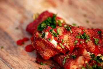 Sweet red pepper stuffed with cream cheese, wrapped in bacon and grilled