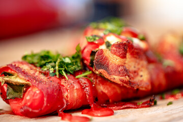 Sweet red pepper stuffed with cream cheese, wrapped in bacon and grilled