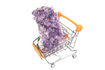 Big single raw natural purple amethyst crystal druse in a small shopping trolley isolated cut out...
