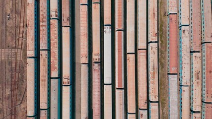 Railway hub showing passenger old crusty trains on tracks next to each other top down view drone moving slowly showing railway tracks positioned parallel. Old Railway Carriages and Wagons 4k 