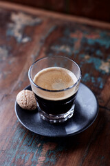 Coffee in glass cup on rustic wooden background. Close up.	