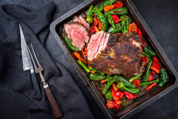 Traditional English barbecue lamb roast with vegetable and gravy sauce offered as top view in a...