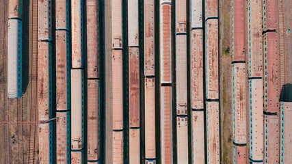 Railway hub showing passenger old crusty trains on tracks next to each other top down view drone moving slowly showing railway tracks positioned parallel. Old Railway Carriages and Wagons 4k 