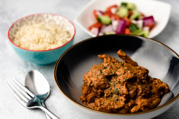 Chicken Makhani with rice, bread and onion salad