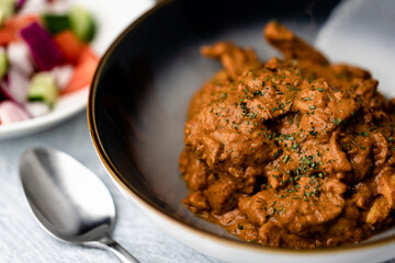 Chicken Makhani with rice, bread and onion salad