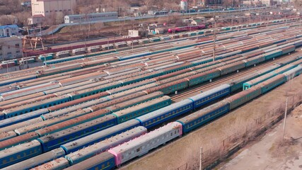 Railway hub showing passenger pink old crusty trains on tracks next to each other top down view drone moving slowly showing railway tracks positioned parallel. Old Railway Carriages and Wagons 4k 