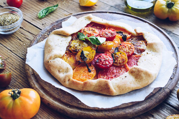 Savory galette with fresh colorful tomatoes and basil