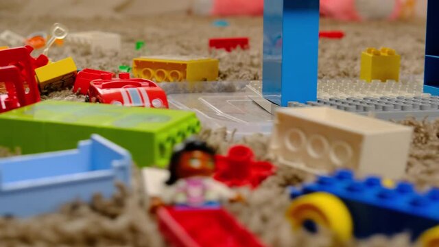 Little boy (4 years old) playing with colorful plastic building bricks on playroom. Filmed using gimble in slow motion.