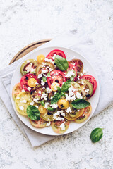 Tomato salad with basil, feta cheese and olive oil